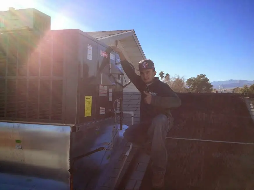 HVAC technician performing Air Duct Cleaning on a rooftop unit in Muhlenberg